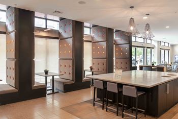 A modern kitchen with a long island and bar stools.